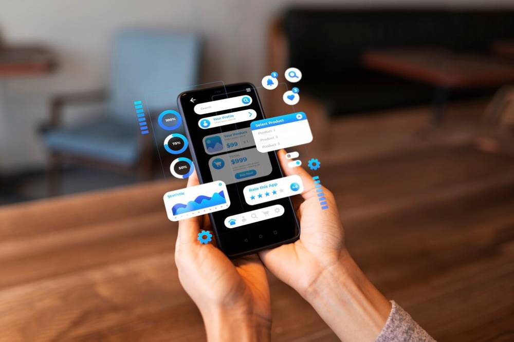 A person holds a smartphone displaying an interactive app interface with charts, ratings, and product options in a cozy setting.