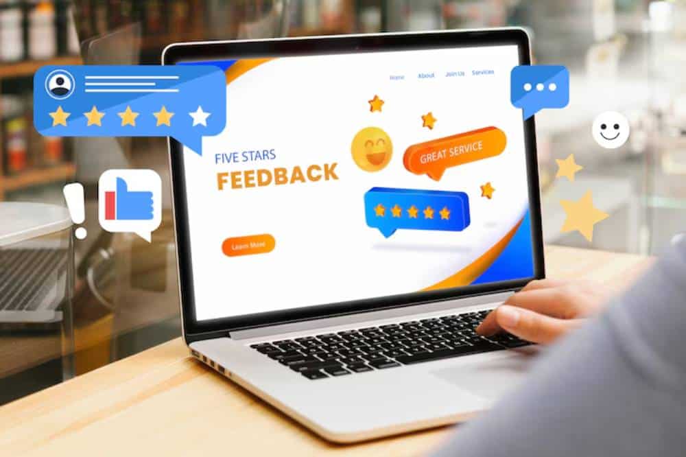 A person using a laptop displaying a feedback page with five-star ratings and positive comments about great service.