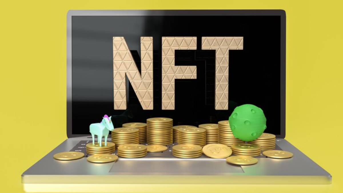 A laptop displays 'NFT' in gold letters, surrounded by stacks of coins, a small unicorn figure, and a green sphere, against a yellow backdrop.