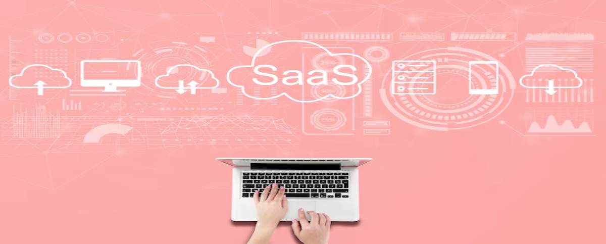 A person typing on a laptop with cloud computing icons and 'SaaS' text overlay on a pink background, symbolizing software as a service.